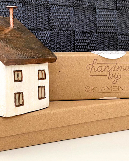 Photo of a decoration with small wood house and recycled paper packaging boxes
