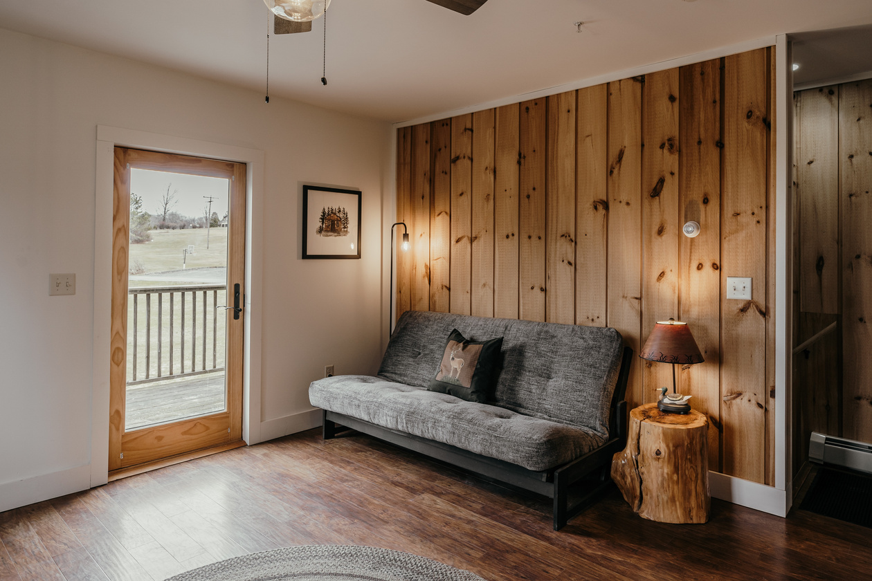 Photo of interior design of a country house featuring wooden decoration wall and grey sofa